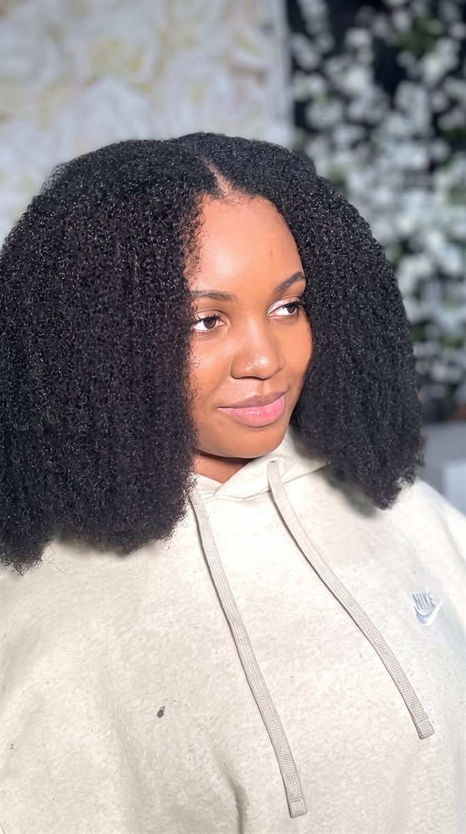 A customer showing off healthy, voluminous natural curls