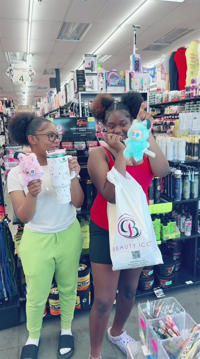Customers with a Beauty Icon shopping bag inside the store